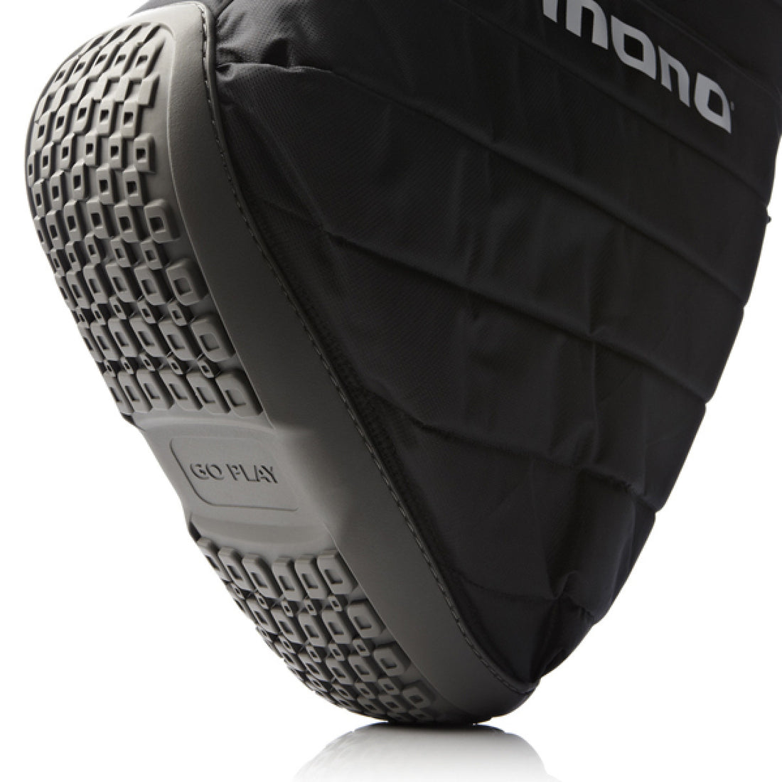 Close-up of a black padded protective pad with a gray textured sole, showing stitched paneling and the partial white &