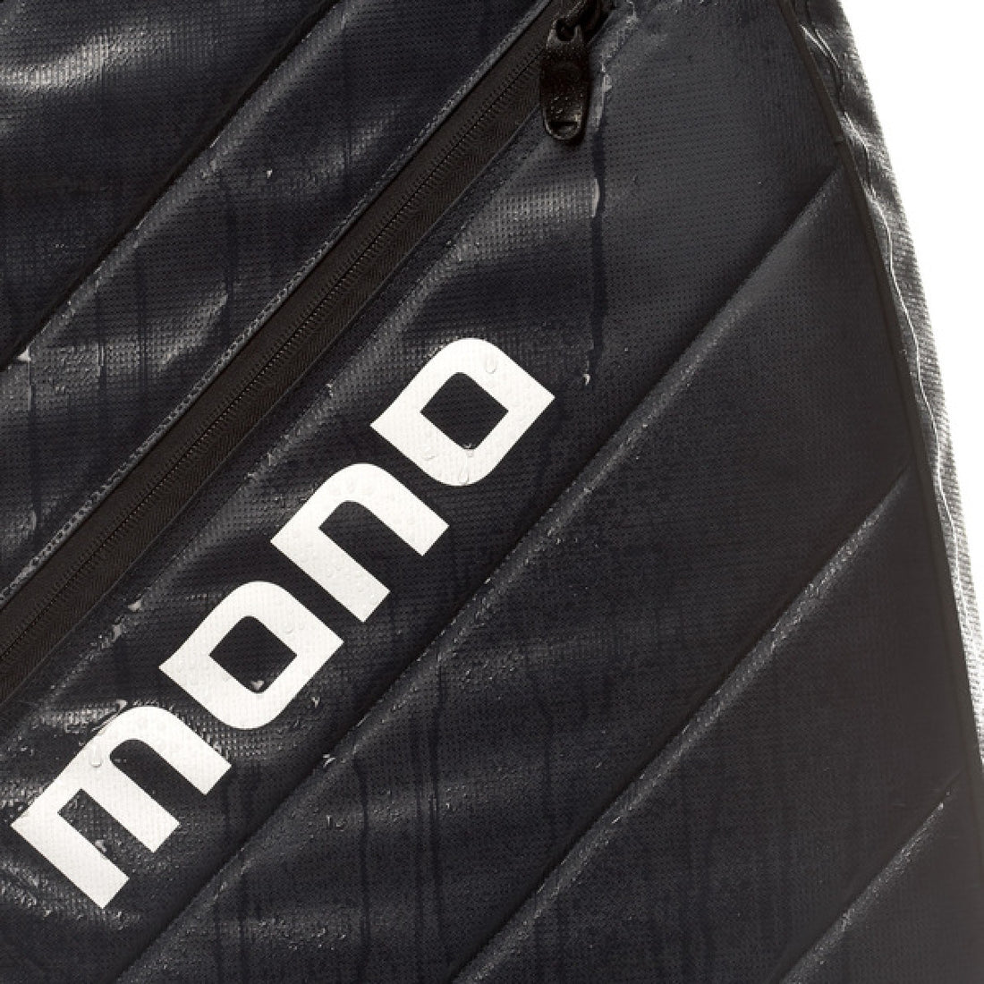 Close-up of a black waterproof sports bag with diagonal stitched panels and a large white &