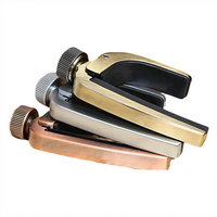 Three vintage-style metal lock picks stacked together on a white background, featuring brass, silver, and copper finishes with black inner tips and knurled adjustment knobs.